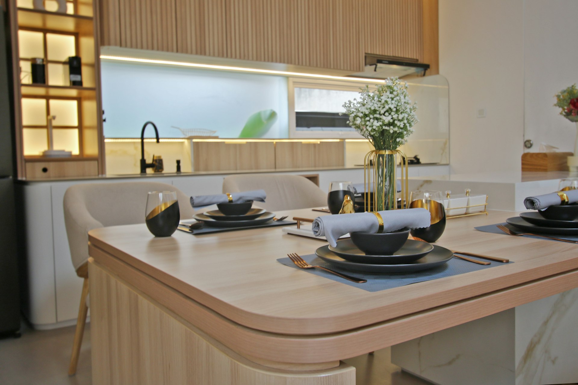 a kitchen with a table set for four